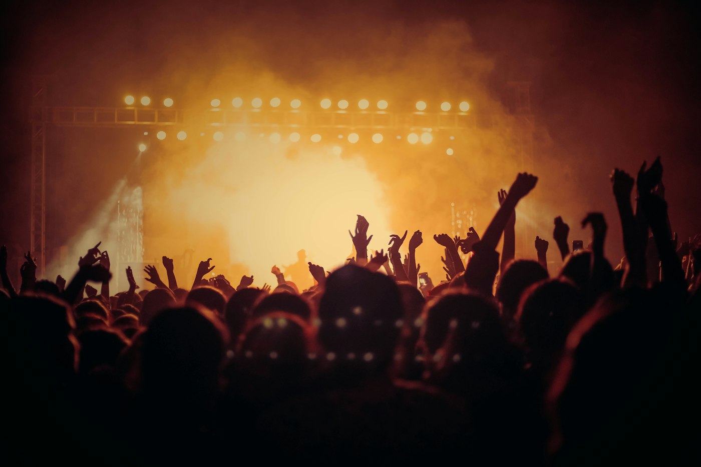 A festival crowd with hands raised